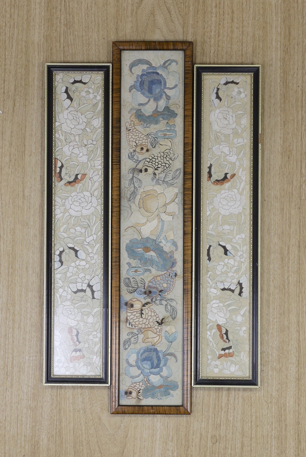 Three 19th century Chinese framed silk embroidered sleeve panels, largest 12 x 55cm